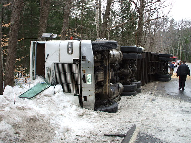 tractor trailer on its side in the snow