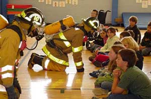 firemen doing a demonstration for kids