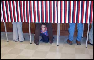 kid sitting between a persons legs under a voting booth