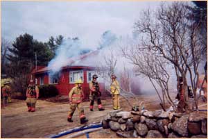 firemen outside a burning building