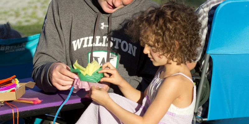 picture of adult helping child with a craft project